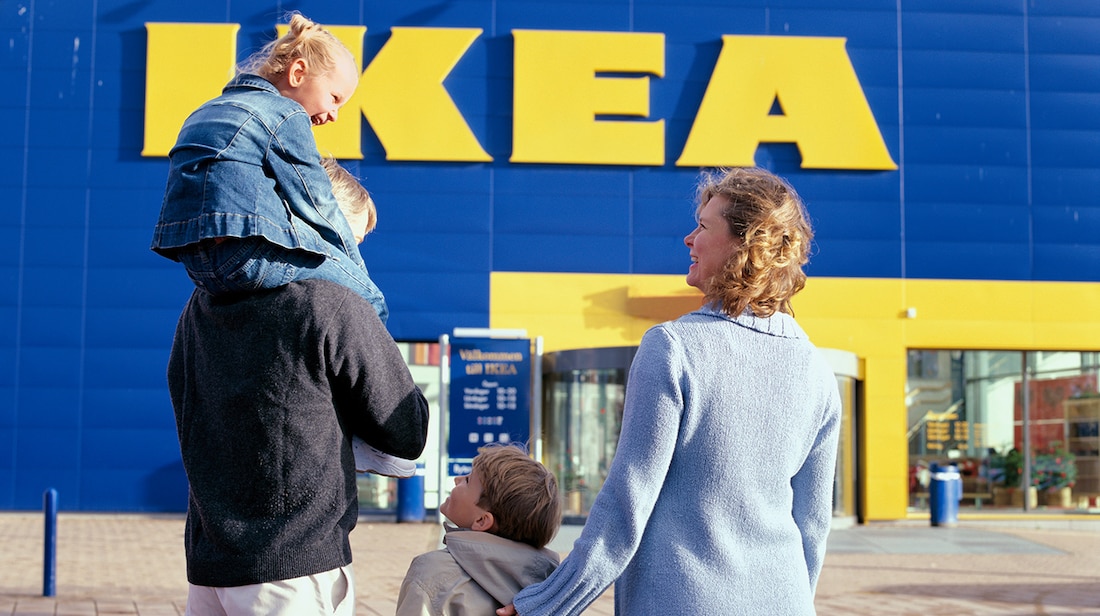 a family walking up to the entrance of an ikea store 6dea7ae2e2f25bc56321429b11efb144